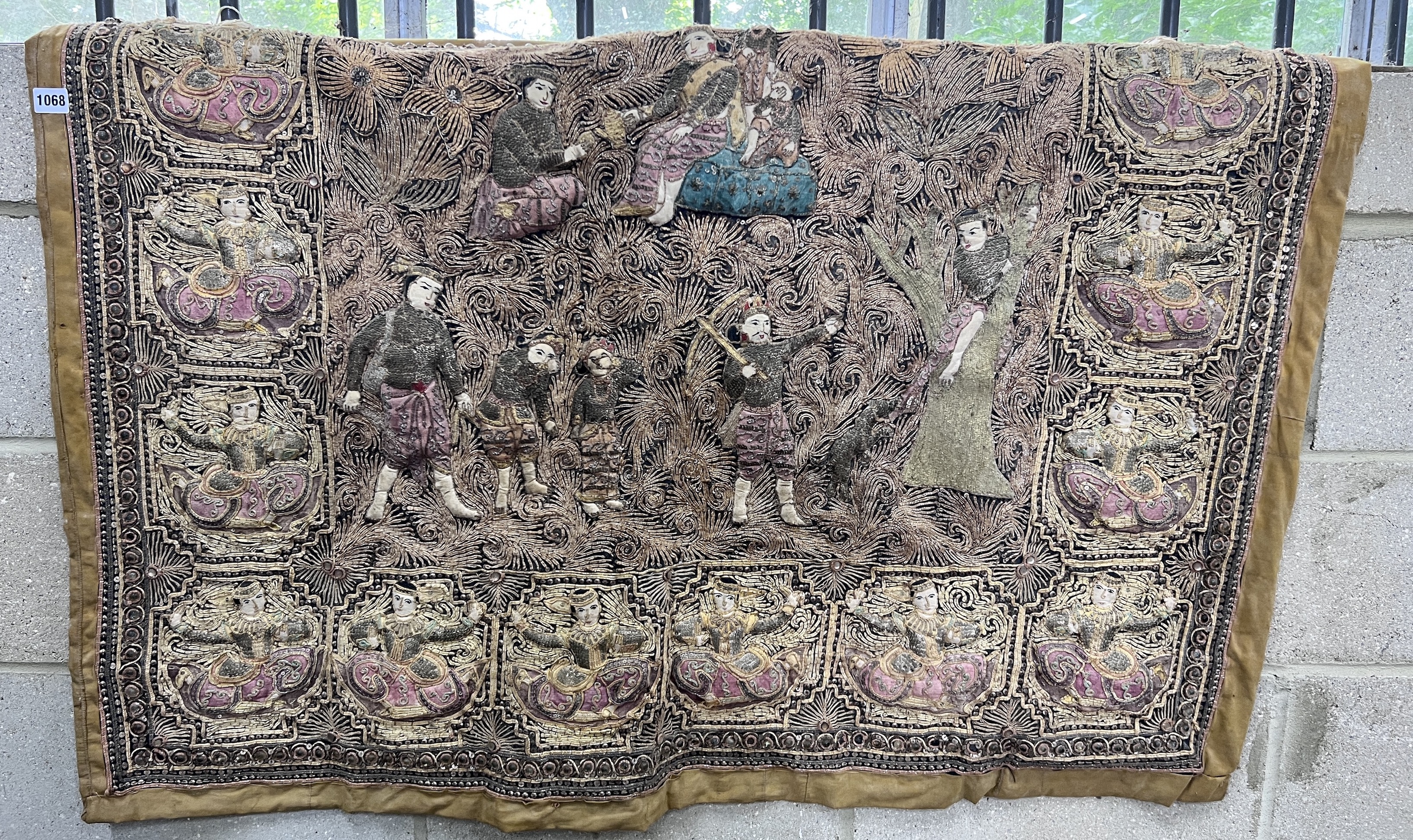 An Indian bullion work embroidered wall panel, depicting figures in a forest, width 124cm, height 90cm